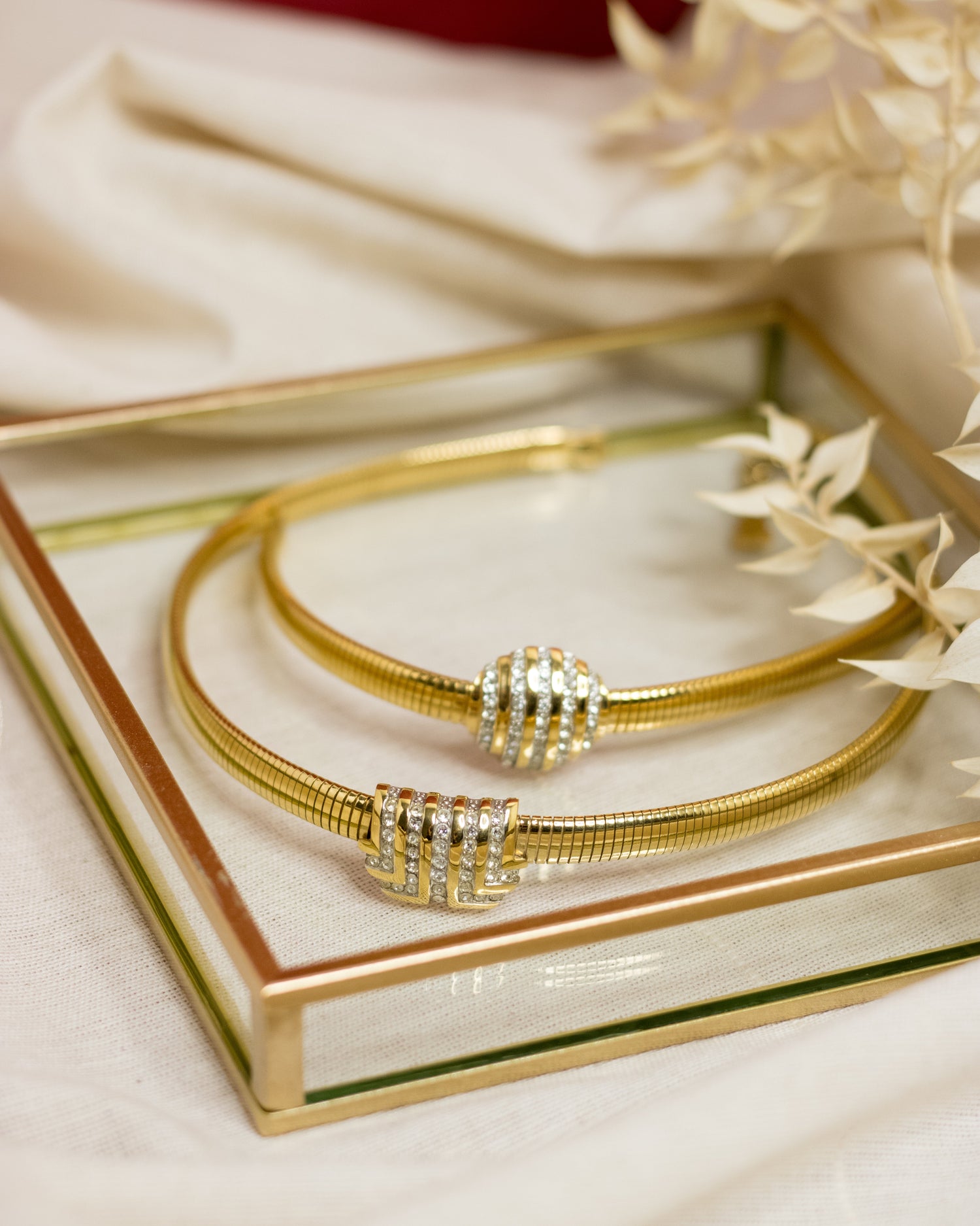 Vintage gold tone omega necklace and matching bracelet. Both items feature a sparkly centrepieces encrusted with rhinestones. The necklace features a Lanvin logo in crystals.